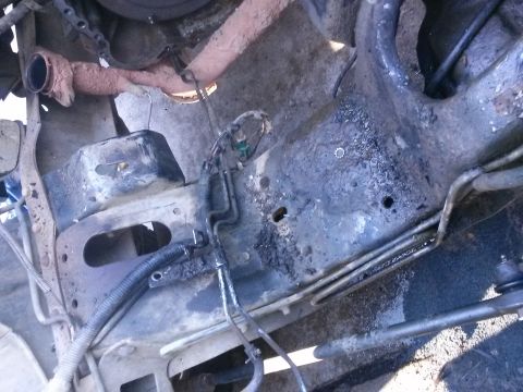 1996 Ford Bronco - Underside view of vehicle chassis and engine bay components, showing hoses and wiring.