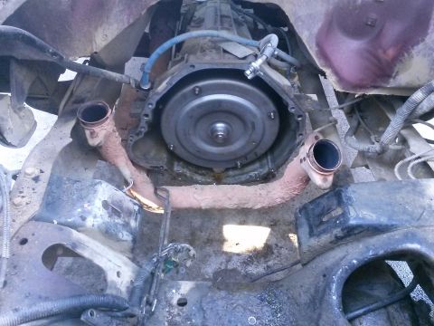 1996 Ford Bronco - The transmission and exhaust system components are visible in this close-up view of a vehicle's undercarriage.