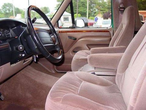 1996 Ford Bronco - Interior view of a 1996 Ford Bronco, highlighting the tan cloth seats and dashboard details.