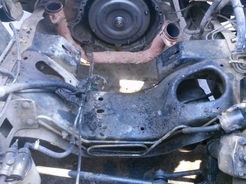 1996 Ford Bronco - Underside view of a vehicle's engine compartment, focusing on the transmission and exhaust system components.