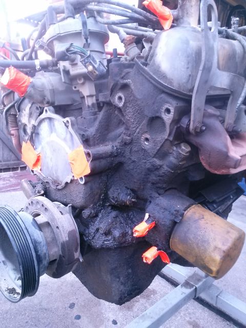 1996 Ford Bronco - Engine block with orange tape on ports and oil filter attached, likely during a re-seal process.