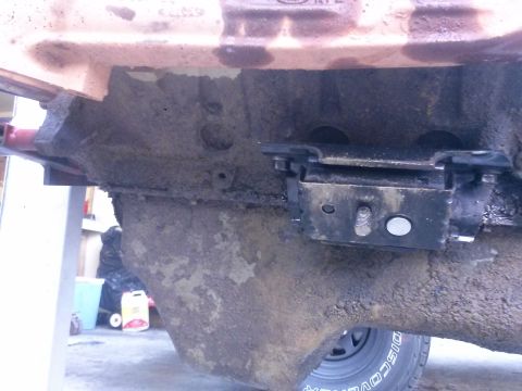 1996 Ford Bronco - Close-up view of an engine block and its mount, likely during a repair or re-seal process.