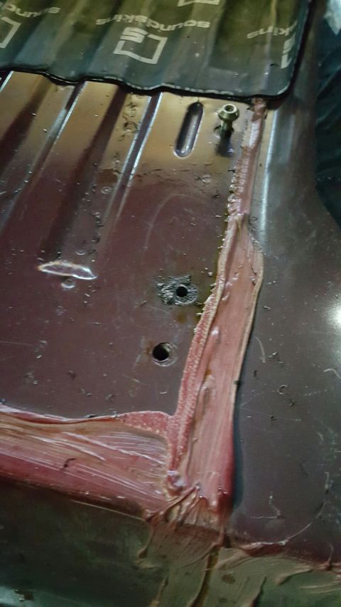 1996 Ford Bronco - Sound deadening material is visible on a metal surface, possibly from a vehicle's interior.