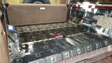 1996 Ford Bronco - Sound deadening material is being installed on the floor and side panels of a vehicle's interior.