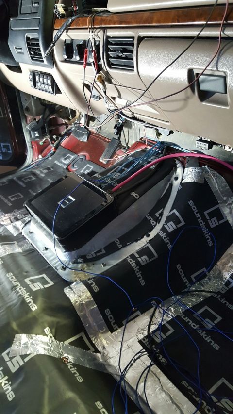 1996 Ford Bronco - Sound deadening material and wiring are being installed inside the vehicle's interior.