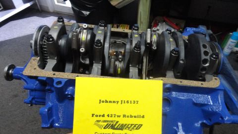 1982 Ford Bronco - A Ford 427w engine rebuild is documented on a yellow sign placed in front of the engine block.