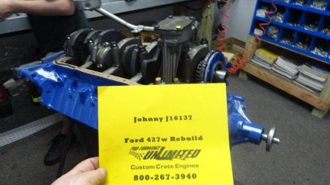 1982 Ford Bronco - Engine block assembly with a yellow sign detailing a Ford 427w rebuild.