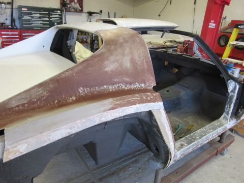 1976 Chevrolet Corvette - This car body is undergoing repairs in a workshop, with tools visible inside the stripped interior.