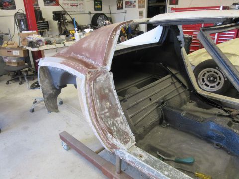 1976 Chevrolet Corvette - This car body, likely a 1975 Chevrolet Corvette, is undergoing repairs in a workshop environment.