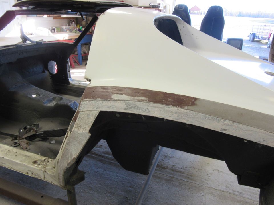 White 1976 Chevrolet Corvette body panel being repaired