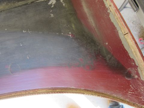 1976 Chevrolet Corvette - This is a close-up view of the interior of a vehicle's fender, revealing wear and tear.