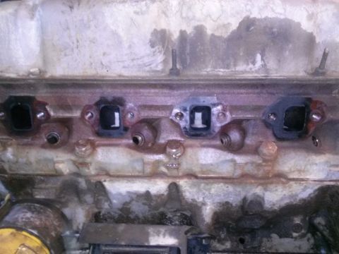 1996 Ford Bronco - This image shows the exhaust manifold ports of an engine, likely during maintenance or repair.
