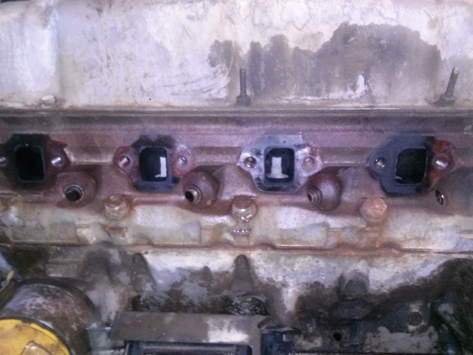 Close-up of engine exhaust manifold ports with gaskets removed