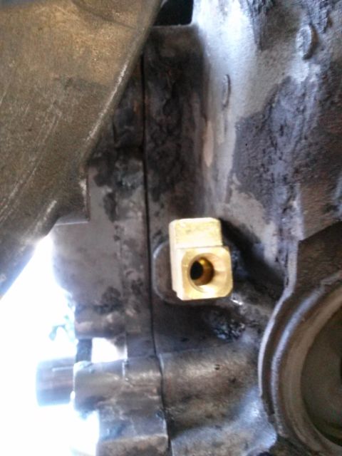 1996 Ford Bronco - A brass fitting is attached to the engine block, likely for a sensor or fluid line.