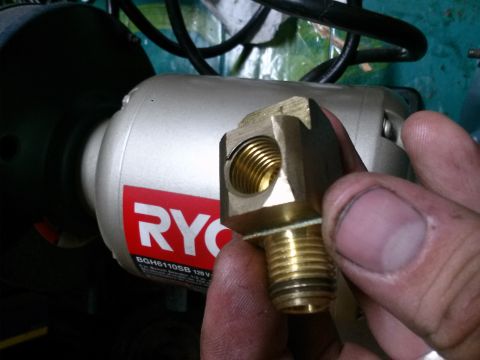1996 Ford Bronco - A brass fitting is held in front of a Ryobi grinder, with Supermotors.net visible at the bottom.
