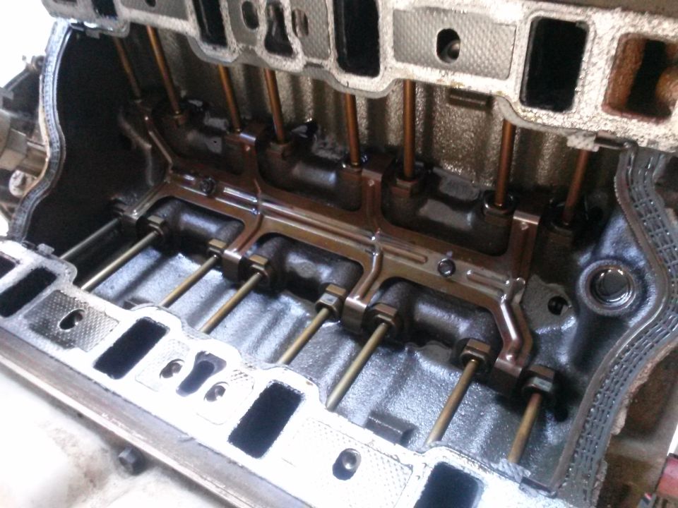 Engine block with pushrods visible inside intake ports