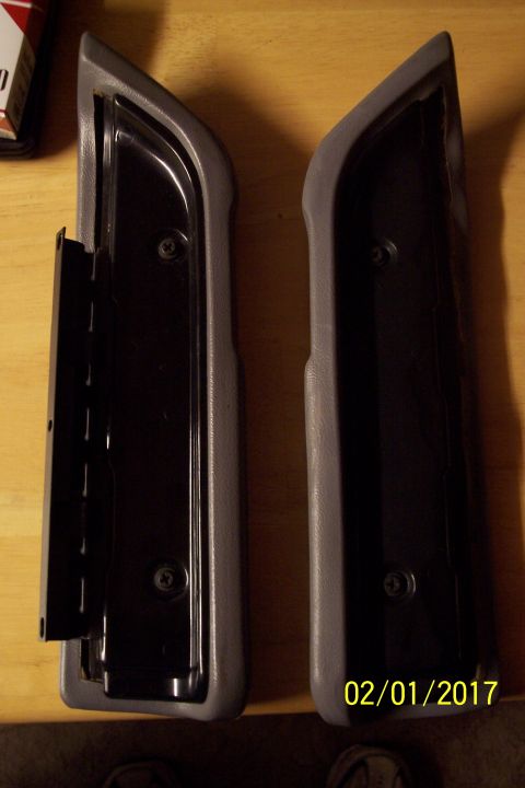 1995 Ford Bronco - Two gray plastic door panel trim pieces are shown, one with an attached metal bracket.
