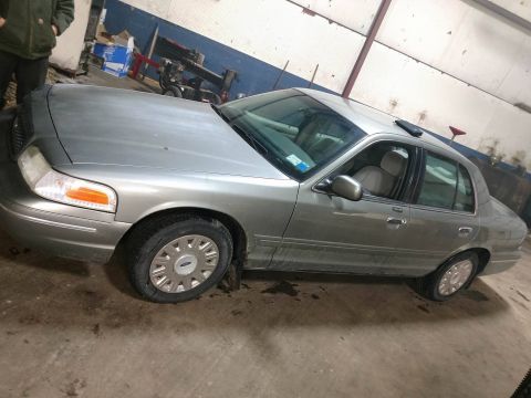 2003 Ford Crown Victoria - Silver 2003 Ford Crown Victoria parked in a garage with a person standing nearby.