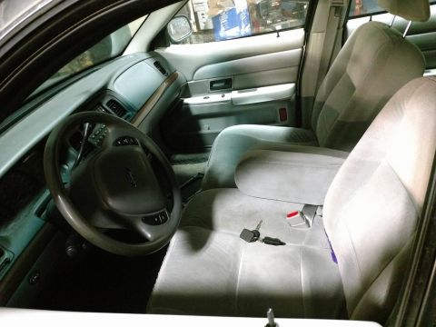 2003 Ford Crown Victoria - The interior of a 2003 Ford Crown Victoria, cloth seats and a spacious cabin.