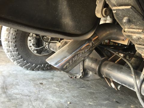 1995 Ford Bronco - A close-up view of the rear axle and exhaust system of a 1995 Ford Bronco, featuring a polished exhaust tip with visible branding.