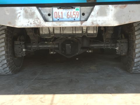 1995 Ford Bronco - Rear view of a modified 1995 Ford Bronco showing the differential, leaf springs, brake calipers, and large off-road tires. The vehicle has…
