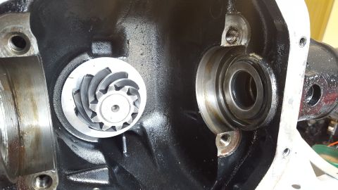 1994 Ford Bronco - Close-up view of the differential housing interior, showing a ring gear and a bearing assembly. The housing is painted black, and the visib…