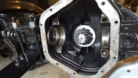 1994 Ford Bronco - The inside of a differential housing is shown, with the ring gear and pinion gear visible. The housing is black and appears to be part of a…