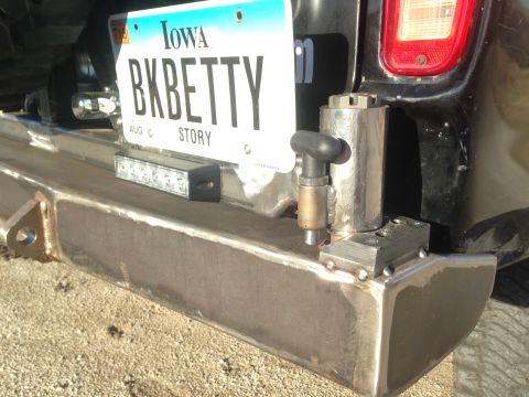 1979 Ford Bronco - A close-up view of the rear bumper and license plate area of a vehicle. The Iowa license plate reads "BKBETTY STORY" and is mounted above a…