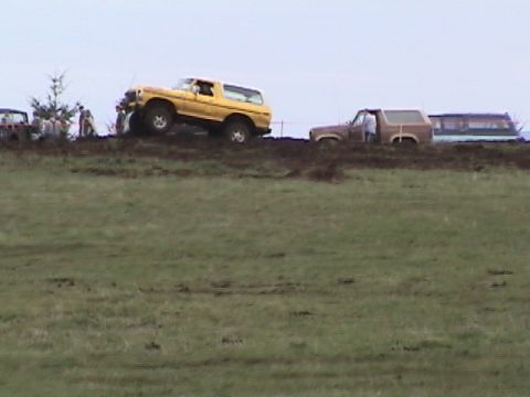 1994 Ford Explorer - Several vehicles are stuck in the mud during an off-road event.