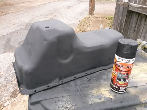 1996 Ford Bronco - A freshly painted black oil pan sits next to a can of Rust-Oleum High Heat paint. The oil pan appears to be for a classic truck or SUV.