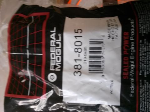 1996 Ford Bronco - A close-up shot of a black plastic bag with white and red text. The bag appears to be packaging for an automotive part, featuring brand nam…