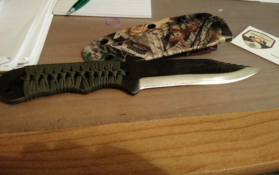 Hunting knife with green paracord handle and camouflage sheath