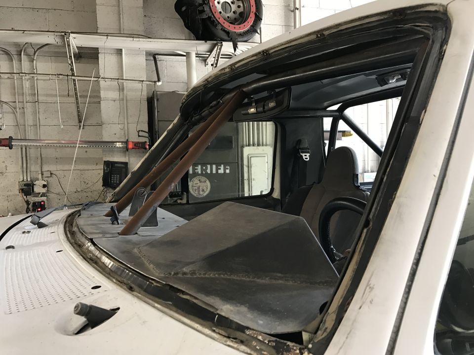Windshield frame and roll cage of a truck in a shop