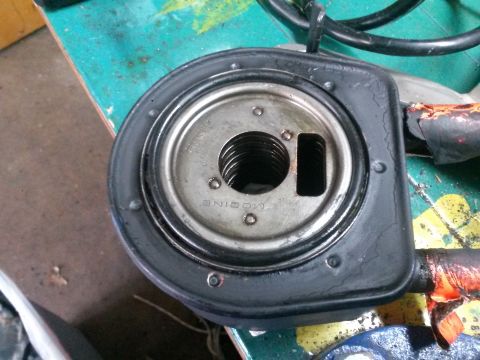 1996 Ford Bronco - A close-up view of an oil filter housing with the word "MODINE" visible on the metal component. The black rubber gasket shows signs of crac…