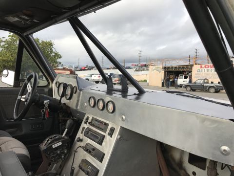 1990 Ford Bronco - Photo of a custom aluminum dashboard and roll cage inside a truck, not a technical document.