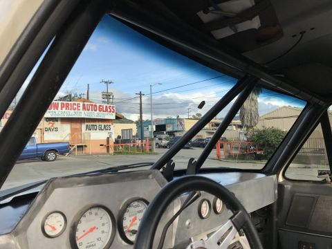 1990 Ford Bronco - Photo from inside a truck cab looking out at a street, not a technical document.