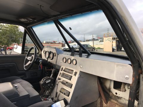 1990 Ford Bronco - Photo of a truck interior with custom aluminum dash and gauges, not a technical document.