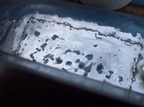 1990 Ford Bronco - Close-up of a metal panel showing rust damage and recent weld repairs.