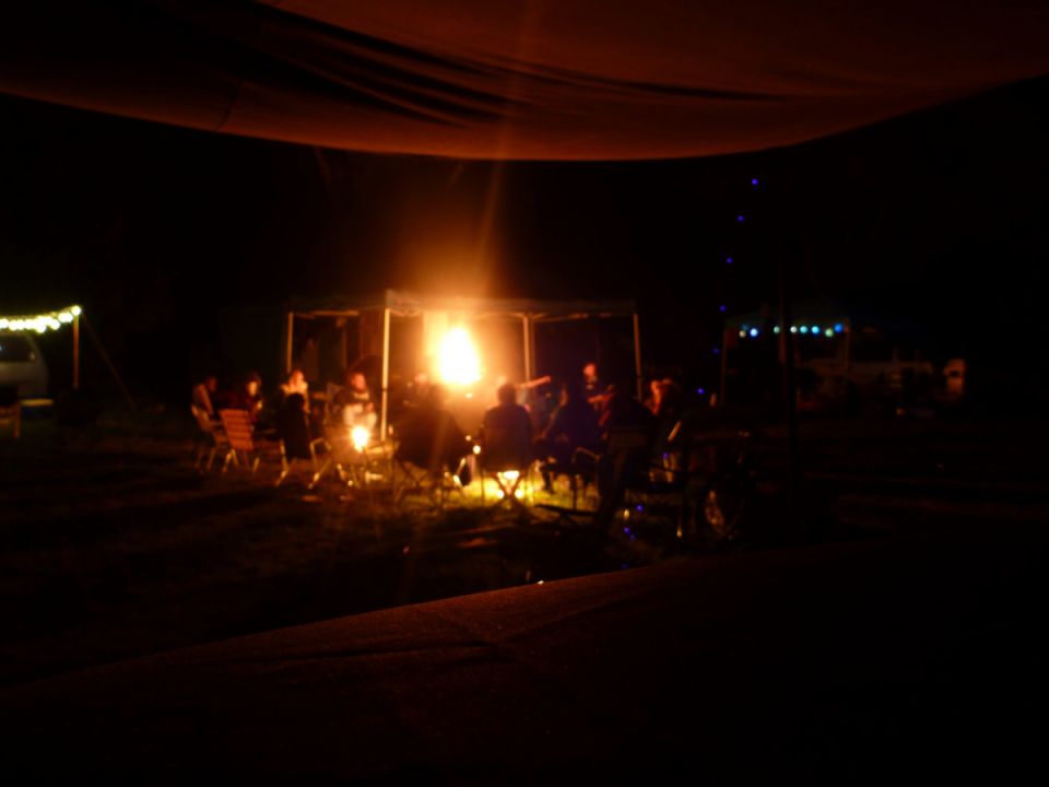 People gathered around a campfire at night.