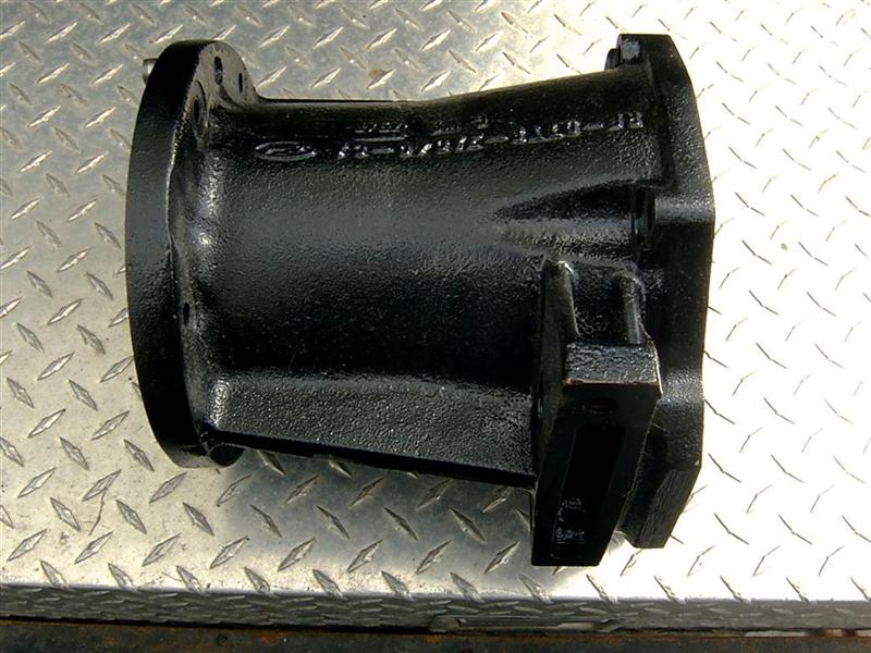 Black plastic automotive part with flange on one end and splines on the other