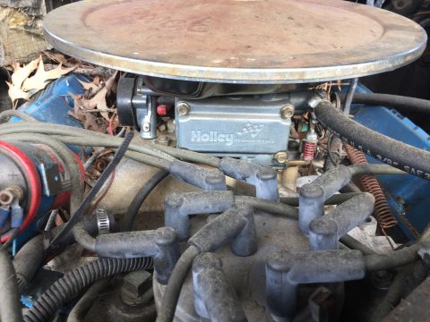 1979 Ford Bronco - Close-up of a Holley carburetor and spark plug wires in an engine bay.