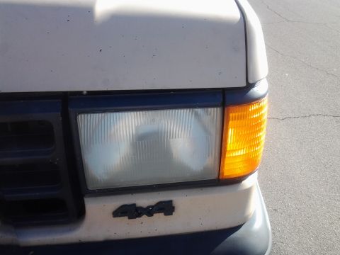 1991 Ford Bronco - Front corner view of a 1991 Ford Bronco, showing the headlight and turn signal assembly.