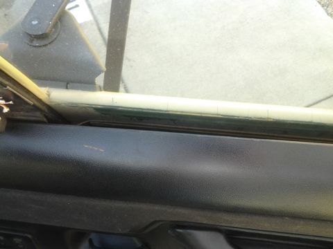 1991 Ford Bronco - Close-up view of the interior door panel and window frame of a vehicle.