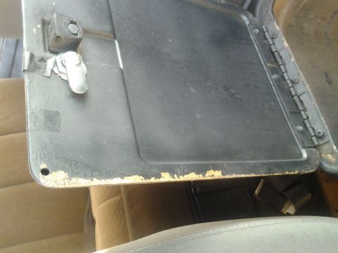 1991 Ford Bronco - Interior view of a vehicle's glove box, showing the latch mechanism and hinges.
