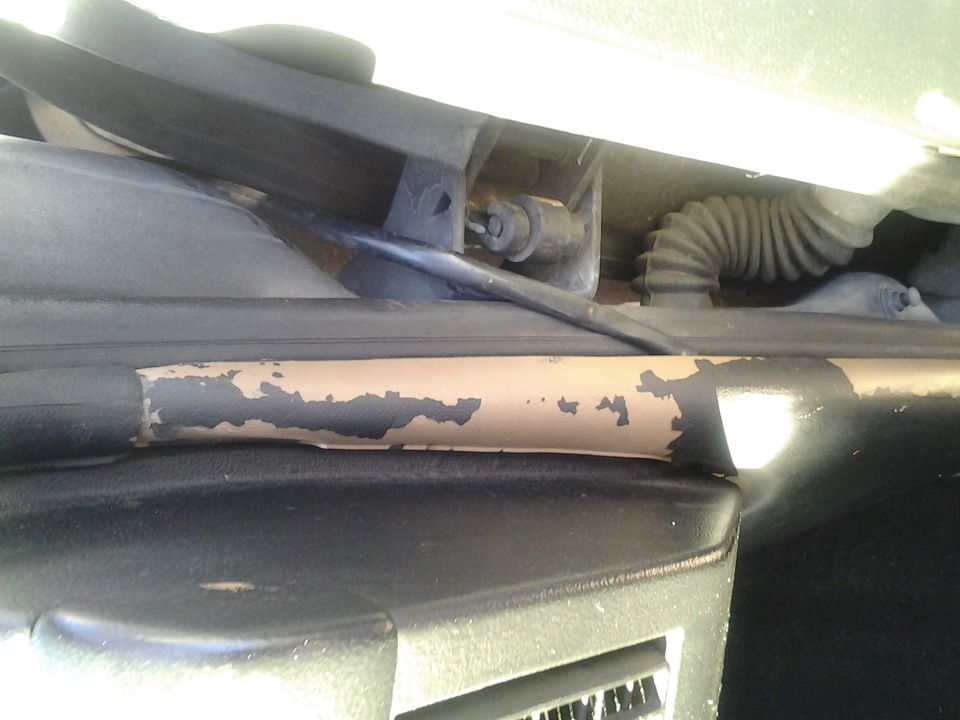 Peeling paint on door jamb and black corrugated wiring conduit visible