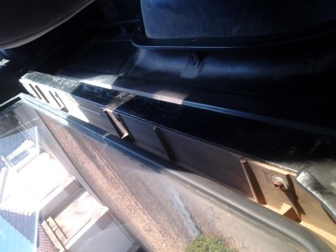 1991 Ford Bronco - Interior view of a black plastic trim piece with visible metal mounting clips.