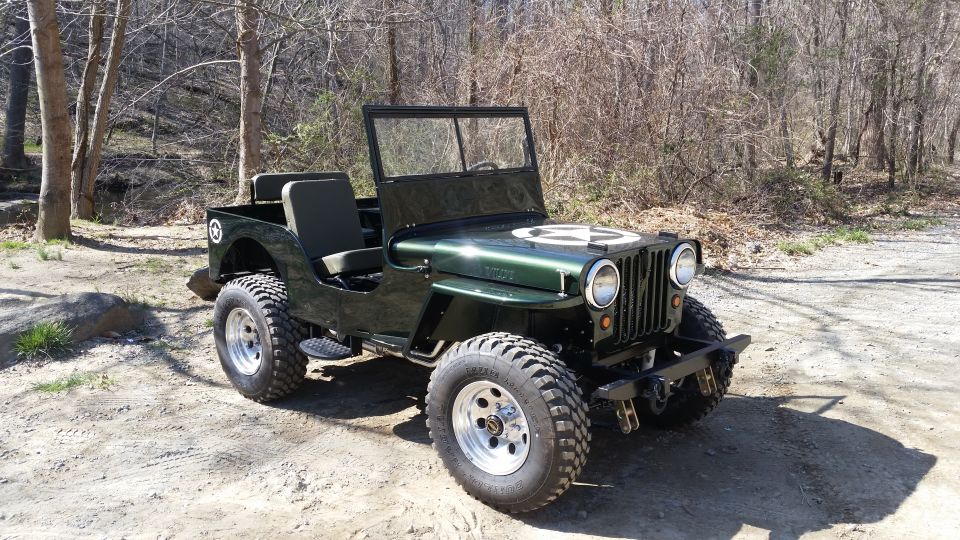 Dark green 1948 Willys CJ-3A Jeep with white star emblem on hood