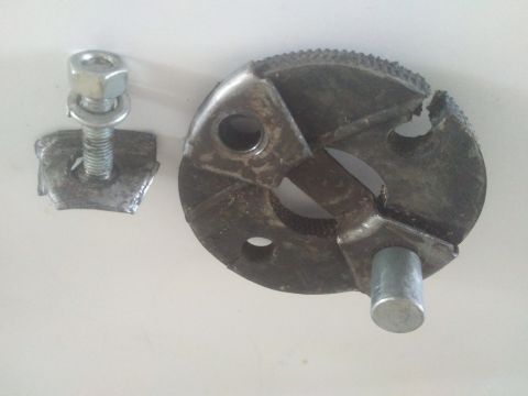 1980 Ford Bronco - Close-up of a pipe cutter wheel and a bolt with nut and washer.