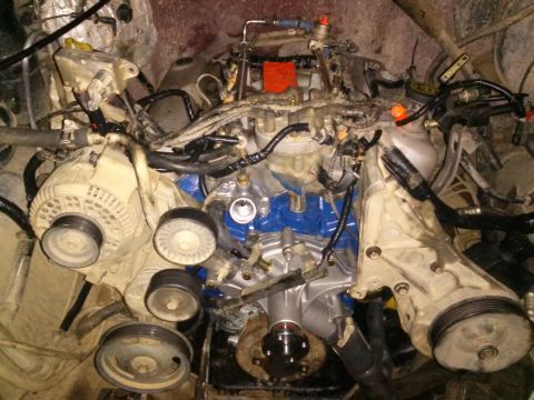 1996 Ford Bronco - A close-up, top-down view of a Ford V8 engine, likely from a 1996 Bronco, showing the alternator, power steering pump bracket, and various…