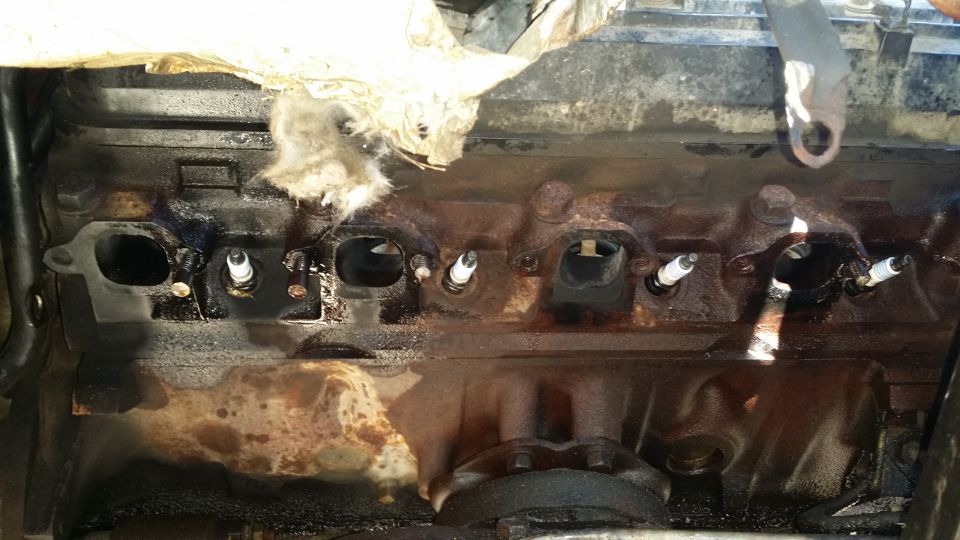 The hard part. I fully expected to not even get to 50% completion today. Both bolts in cylinder 4 (far left port in picture) were broken by one of the previous owners. The rear bolt in cylinder 3 was also broken but not visible with everything on. So, I only had 2 break on me, one broken stud extracted with a stud extractor. The rest will need to be drilled, no way around it. I still have the left side to do, mind you. Could only get out one stud, so off come the heads. Damn it.
